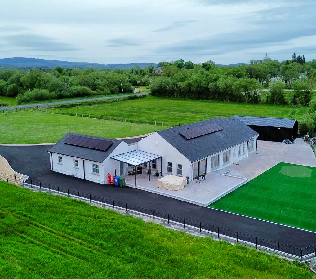 Solar panels installed across the roofs of a single-storey home